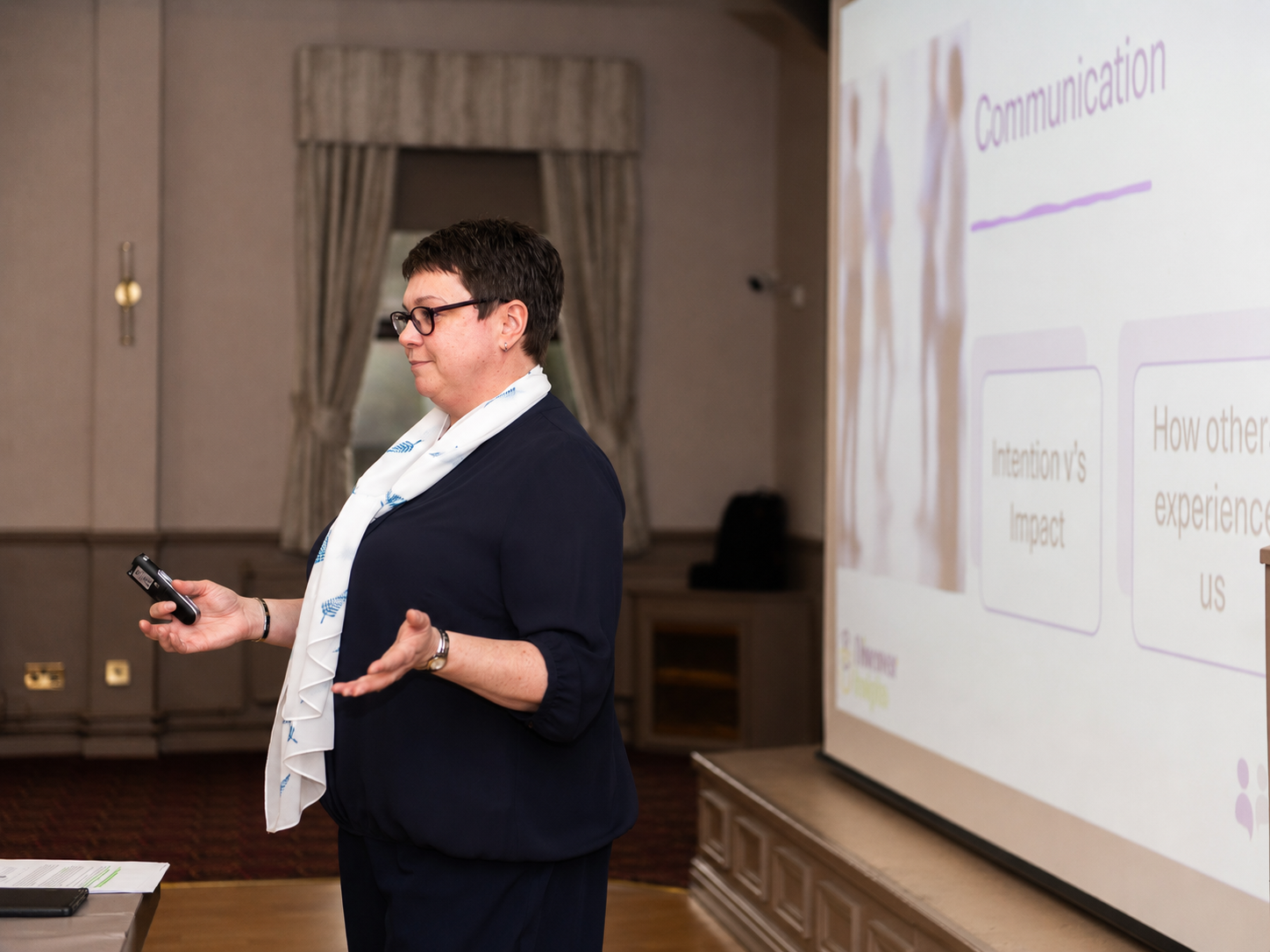 Joanne presenting at a conference and sharing why people misunderstand each other at work
